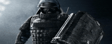 a man in armor holds a briefcase in his hand