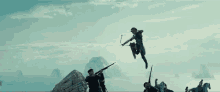 a woman is jumping in the air while holding a bow and arrow while a group of men are riding horses .