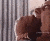 a close up of a man and a woman kissing .