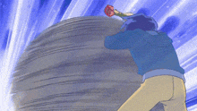 a man in a blue jacket is pushing a large rock while holding a baseball bat .