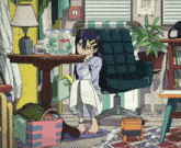 a girl sits on the floor in front of a table with a fish bowl in it