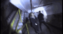 a blurry photo of people walking down stairs in a dark room