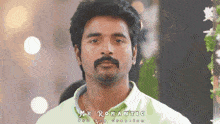 a man with a mustache is wearing a green shirt with the words mr romantic on the bottom