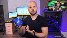a man is holding an intel core processor box