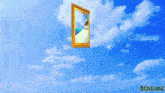 a framed picture of a beach is floating in the air