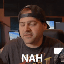 a man wearing a hat and a t-shirt with the word nah on it