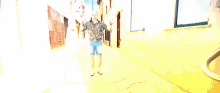 a pixelated image of a man dancing in a narrow alleyway