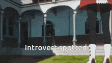 a person standing in front of a building with the words introvert spotted on the bottom