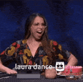a woman is sitting at a table with her hands on her breasts and the words laura dance written on the bottom
