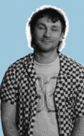 a man wearing a black and white checkered shirt with a t-shirt that says ' sd ' on it