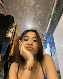 a woman wearing a gold watch is making a face