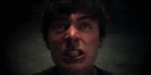 a close up of a man screaming with his mouth wide open