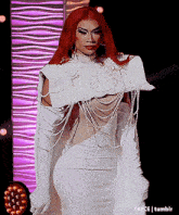 a drag queen with red hair is wearing a white dress and white gloves