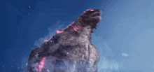 a monster is standing in the water with its mouth open and glowing red .