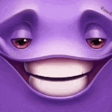 a close up of a purple cartoon character 's face with a smiling face .