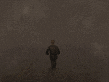 a man in a suit is running down a road in the fog