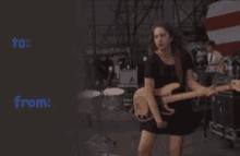 a woman is playing a guitar on a stage with the words to and from written below her