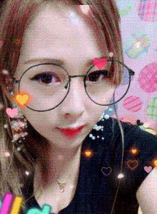 a woman wearing glasses and a black shirt takes a selfie