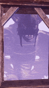 a picture of a monster in a wooden frame with a purple sky in the background