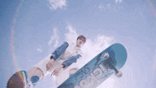 a person is holding a skateboard that says kickout