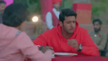a woman wearing a pink hoodie with the word love on it