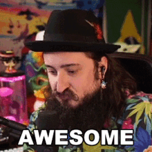 a man with a beard is wearing a hat and ear buds and says awesome