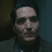a close up of a man 's face with a serious look on his face