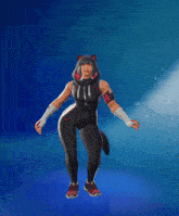 a woman in a black and red outfit with a hoodie on stands in front of a blue background