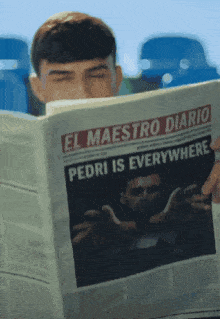 a man is reading a newspaper that says " pedri is everywhere "