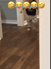 a baby is running in a hallway surrounded by laughing faces