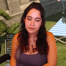 a woman is sitting in front of a screen that says us https
