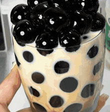 a person is holding a glass filled with bubbles