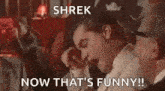 shrek now that 's funny ! a man in a suit and tie is yawning in a crowd of people .