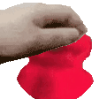 a close up of a person 's hand holding a red heart .