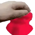 a close up of a person 's hand holding a red heart .