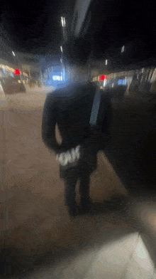 a blurry picture of a person walking with a bag that says louis vuitton on it