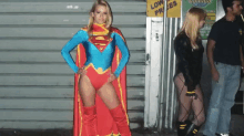 a woman in a superhero costume stands in front of a sign that says low prices