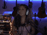a woman singing into a microphone in front of a sign that says ' aosite ' on it