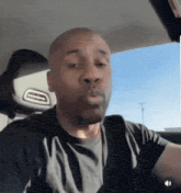 a man is blowing a kiss in a car