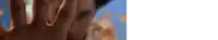 a close up of a person 's hand with a blue sky in the background .