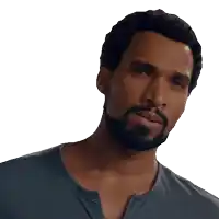 a man with a beard wearing a blue shirt looks to the side