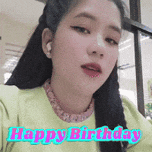 a woman is wearing a green shirt and says happy birthday
