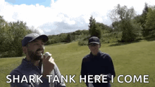 a man and a woman are playing golf and the man is holding a golf ball and says shark tank here i come