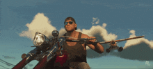 a man riding a motorcycle with a plane in the background and the letter r on the bottom