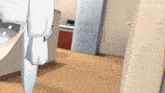 a person is standing in a room with a fridge in the background and a sink in the foreground .