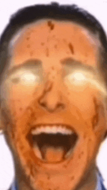 a close up of a man 's face with his mouth open and his eyes shining .