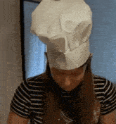 a woman wearing a chef 's hat and striped shirt