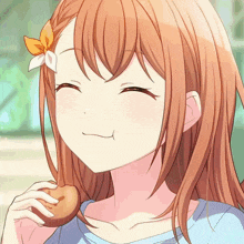 a girl with a flower in her hair is smiling and eating a donut