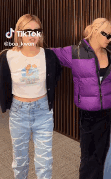 two women standing next to each other with tiktok written on the bottom