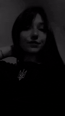 it is a black and white photo of a woman taking a selfie .